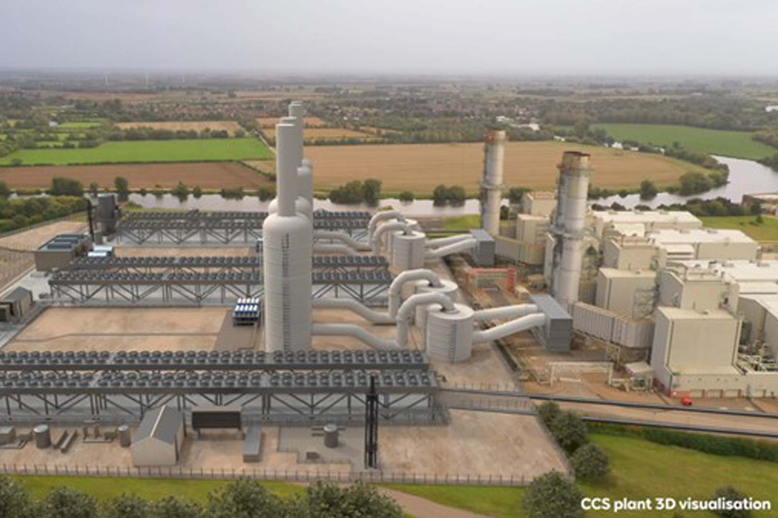 An aerial view of a CCS plant with large structures and pipelines, surrounded by fields and a river.