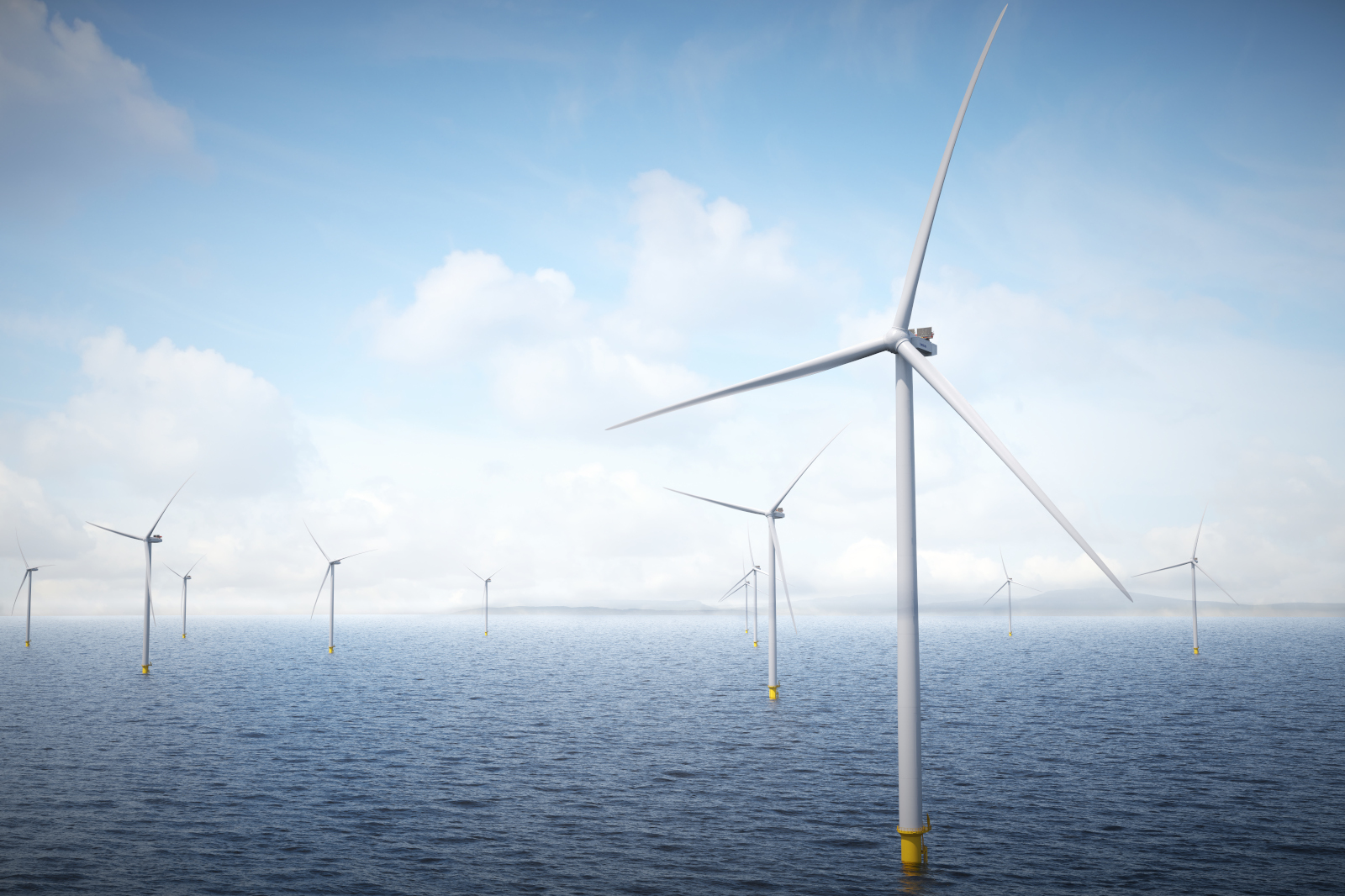 Five wind turbines stand in the ocean at sunset, with colourful clouds in the sky and gentle waves below.