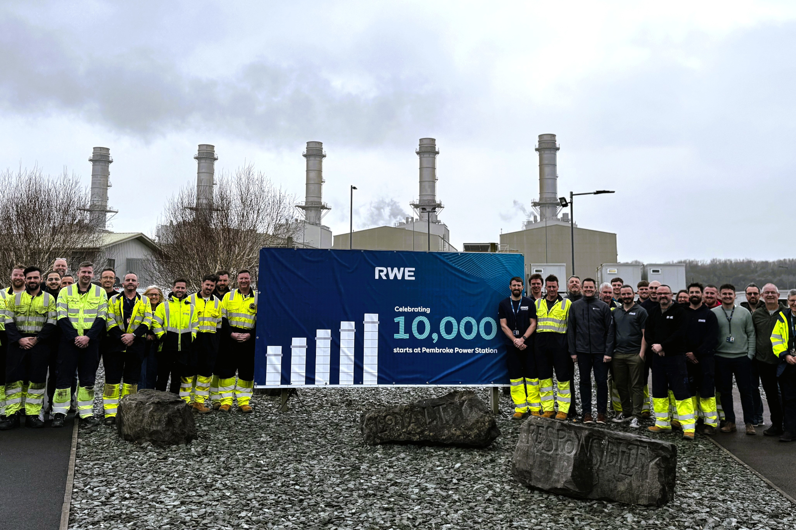 Group of workers in high-visibility clothing at Pembroke Power Station, celebrating 10,000 operational starts.