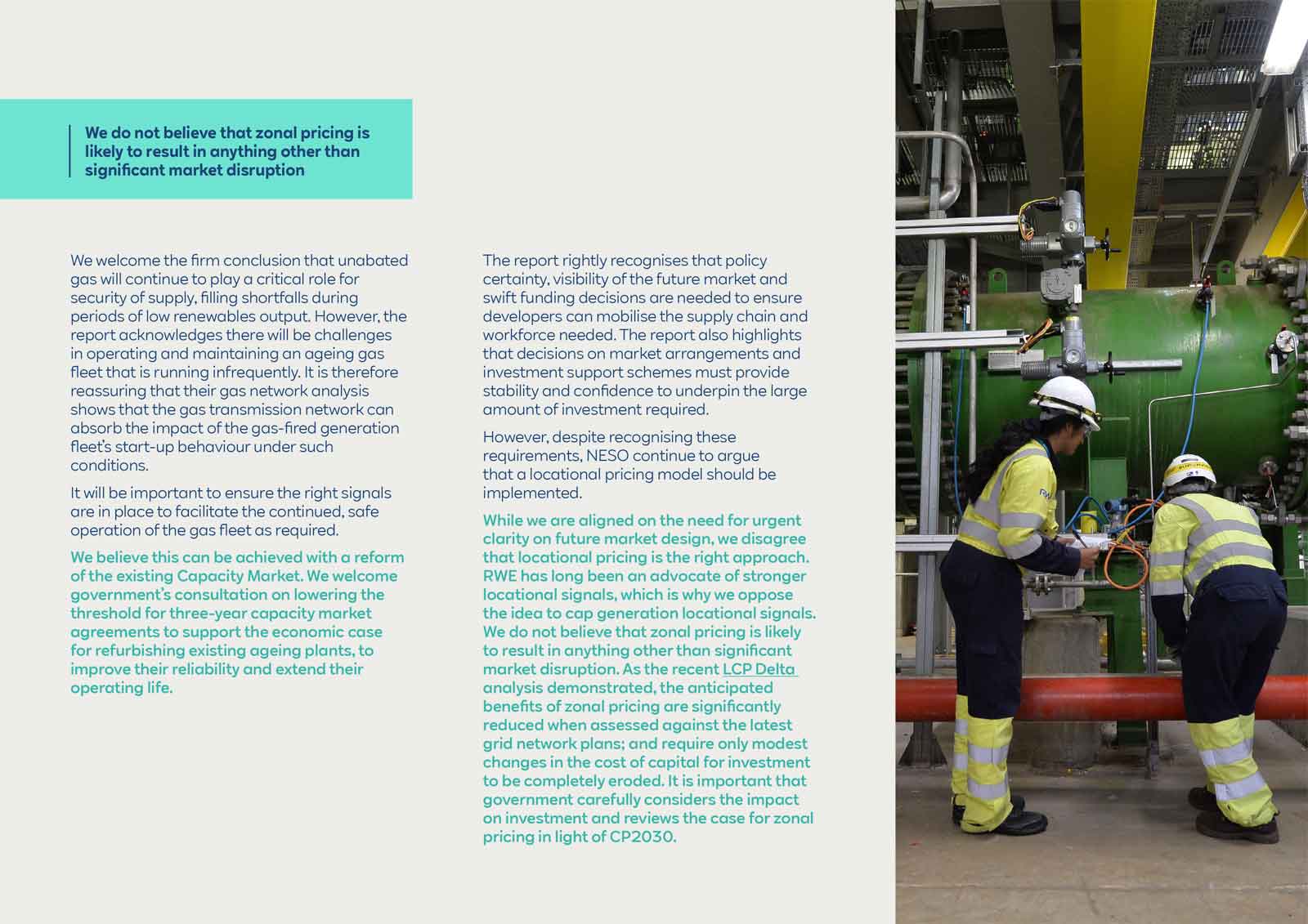 Two workers in safety gear inspecting machinery in an industrial setting, surrounded by pipes and equipment.